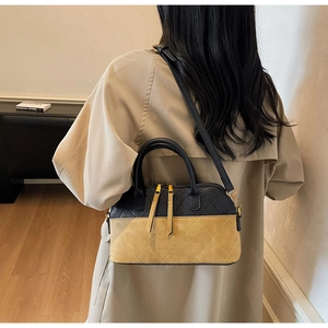 Detail showing the vintage quilted crossbody bag styled with a beige trench coat