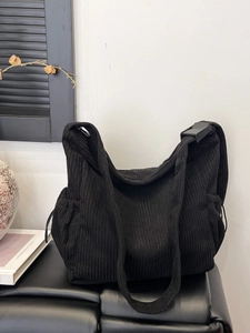 Large black corduroy tote bag with adjustable shoulder strap and drawstring pockets