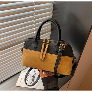 Detail of vintage quilted shell bag with contrast stitching and dual zipper closure