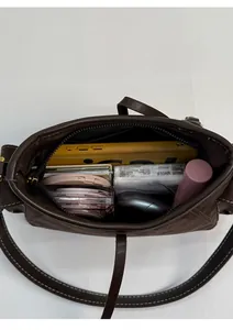 Top-down view of spacious brown suede tote bag showing internal storage for essentials