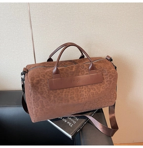 Vista dettagliata della borsa da viaggio maculata marrone con marchio Hoco Bag in rilievo