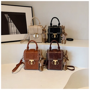 Detailed view of structured square phone bags in four colors with gold T-locks and bunny charms