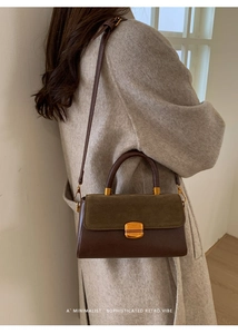 Detail of retro dual-material handbag with gold twist lock and adjustable crossbody strap