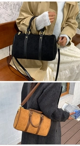 Detail of vintage matte boston bag with leather handles and metallic zipper closures