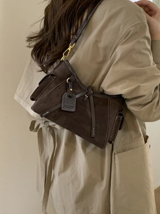 Deep coffee suede tote bag with chain strap shown on model in khaki autumn trench coat