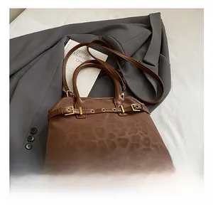 Detail of leopard print tote bag with gold hardware and stylish detachable shoulder strap