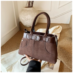 Detailed view of deep brown vintage matte crossbody bag with silver buckle and top handle