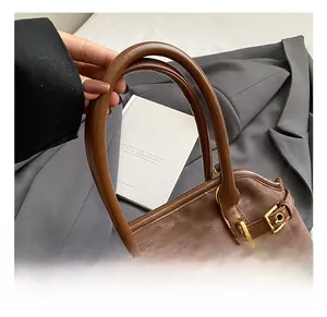 Close-up of brown leopard print tote bag with golden metal buckle and leather handle