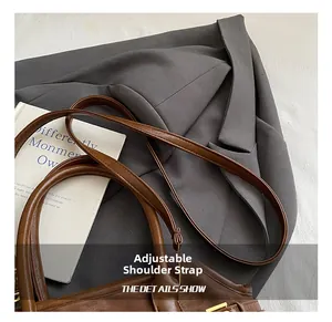 Detail showing the adjustable leather strap and golden metal buckle of the leopard tote bag