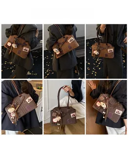 Detailed views of vintage brown tote bag with apple embroidery and tassel charms