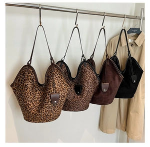 Macro display of large suede tote bags in leopard print, brown and black leather finishes