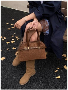 Brown leopard print tote bag with gold buckle hardware styled with autumn boots