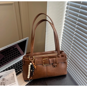 Brown vintage faux leather shoulder bag with buckle detail and stylish bead charm