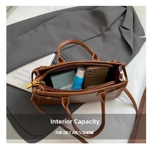 Interior view showing spacious capacity with a smartphone and lipstick in a brown tote bag