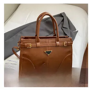 Detailed view of brown vintage satchel showing matte leather texture and hardware