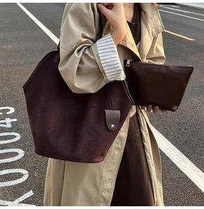 Detail of coffee brown suede tote bag and matching pouch in a retro urban street style