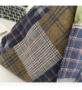 Macro shot of thick plaid wool fabric with navy and beige patterns and stitching