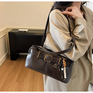 Vintage dark brown faux leather shoulder bag with buckle details and beaded charm