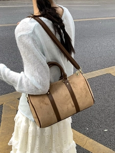 Brown frosted Boston shoulder bag with top handles shown in an outdoor street style