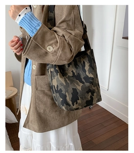 Detailed view of camo canvas shoulder bag showing vintage military style texture