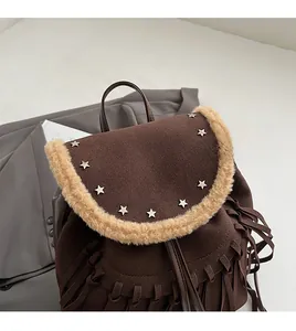 Detail of dark brown fringe backpack featuring star studs and cream faux fur trim