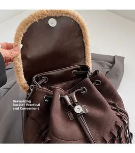 Detail of vintage brown backpack showing drawstring closure and plush trim texture