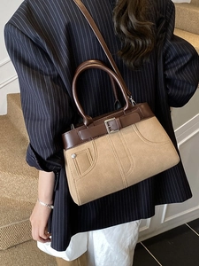 Vintage khaki and brown crossbody bag with matte finish shown on a model outfit