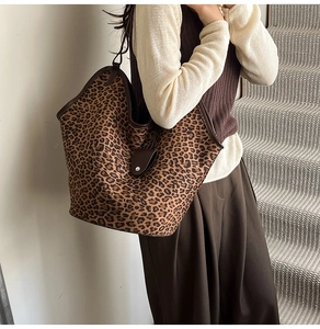 Detailed view of vintage leopard print tote bag with brown leather trim and handle