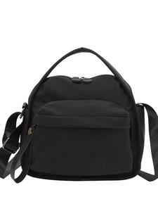 Minimalist black lightweight crossbody bag with top handle and adjustable shoulder strap