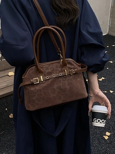 Brown leopard print tote bag in matte suede leather shown in a stylish outdoor setting