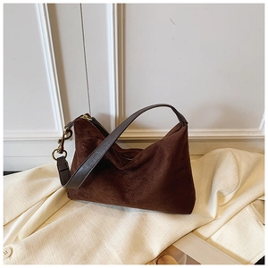 Detail view of coffee suede hobo bag fabric texture with premium golden hardware clips