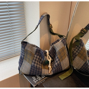 Détail du sac cabas vintage avec bouton de serrage et bandoulière en toile réglable