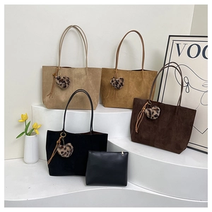 Detail view of large tote bags in four colors with leopard print heart tassel charms