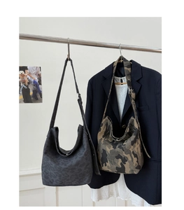 Detail of hobo shoulder bags with camouflage and dark leopard prints and adjustable straps