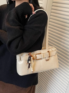 Beige retro buckle handbag with beaded pendant shown as underarm shoulder bag for women