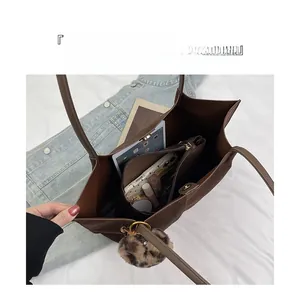 Macro shot of large brown suede tote bag interior showing organized compartments and storage