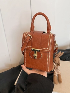 Brown retro vertical mobile phone bag with handle, metal snap, and rabbit doll charm