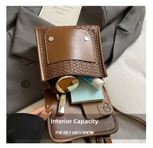 Internal view of the brown leather crossbody bag showing capacity for phone and cosmetics