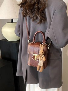 Retro brown leather crossbody bag with vintage gold clasp and cute rabbit charm