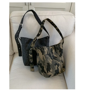 Detail of adjustable wide shoulder straps with metal eyelets on camo and leopard bags