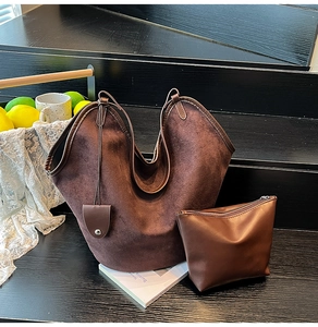 Brown faux suede tote bag set with matching zippered inner pouch on a wooden display
