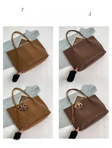 Detail view of brown and coffee leopard print tote bags with fuzzy ball charms