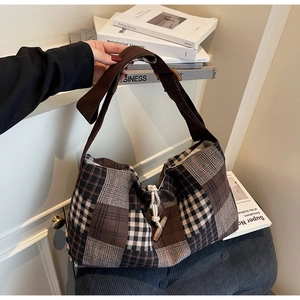 Détail du sac en toile à carreaux avec fermoir à bascule en bois et large bandoulière