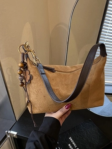 Brown suede shoulder bag with wood bead charm and retro dumpling design for women