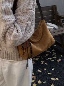 Brown suede hobo bag for women with wooden beads and leaf charms for a vintage look