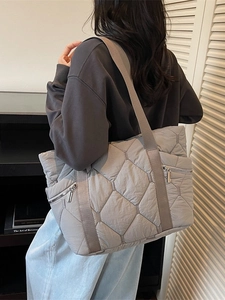 Grey quilted tote bag with diamond stitching and side zipper for autumn/winter commute