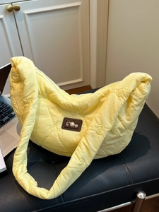 Quilted yellow cloud tote bag with heart patterns and pearl leather patch detail
