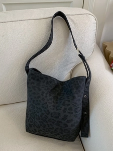 Large black leopard print hobo bag with adjustable wide strap and silver grommets