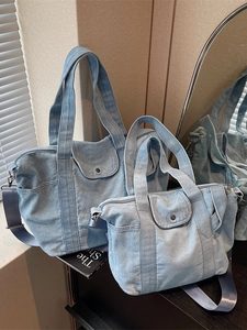Light blue denim tote bag set with adjustable straps and front pocket for casual use