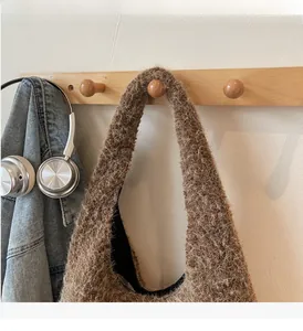 Detail of plush brown faux fur handbag texture with sturdy handle for autumn fashion